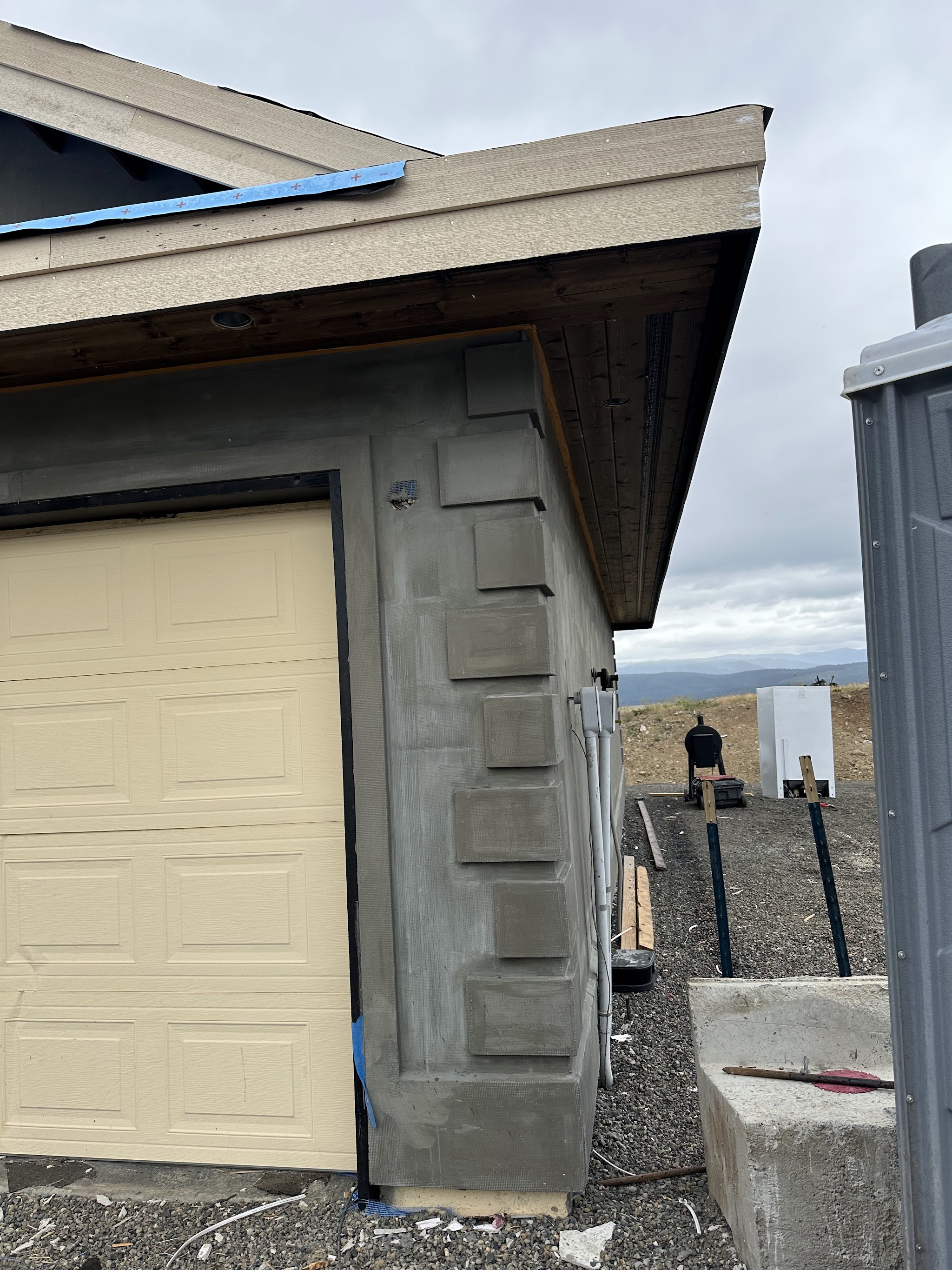 New home under construction with stucco exterior and mountain views, built by Nano Construction in the Yakima Valley